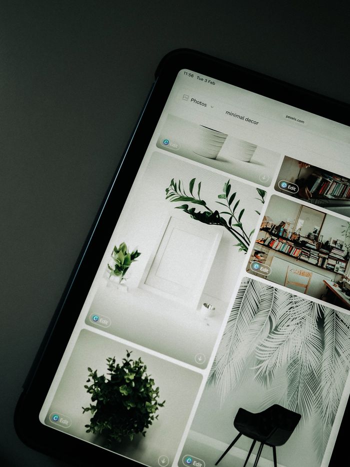 who-we-are A tablet screen featuring images of minimalist decor emphasizing greenery and simple design.